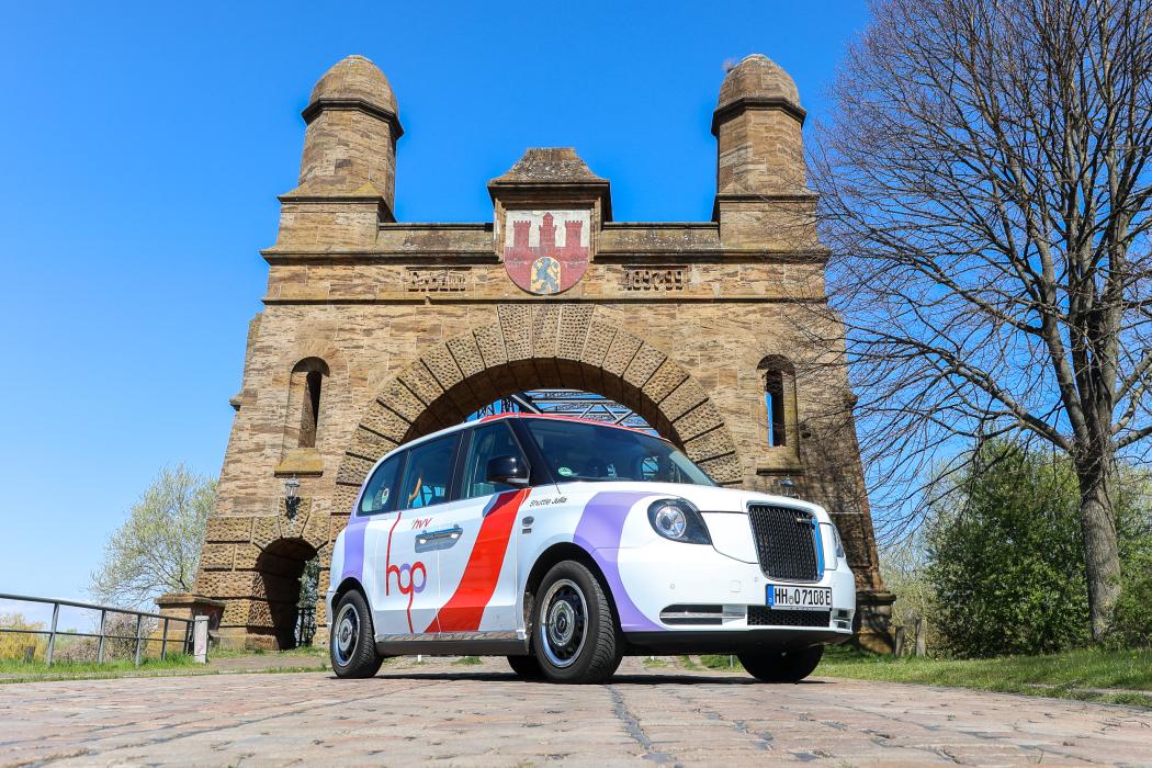 Ein hvv hop Shuttle vor der Harburger Elbbrücke: Ab August 2025 ist der On-Demand-Service im gesamten Bezirk Harburg unterwegs. | Foto: hvv hop